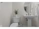 Powder room featuring a pedestal sink, toilet, and decorative accents at 10410 Sablewood Dr # 111, Raleigh, NC 27617