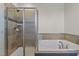 Bathroom showcasing a tiled shower and separate soaking tub at 10410 Sablewood Dr # 111, Raleigh, NC 27617