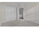 Bright bedroom with carpeted floor and a closet featuring classic paneled doors at 10410 Sablewood Dr # 111, Raleigh, NC 27617