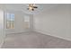 Bedroom with neutral carpet, two windows, and a ceiling fan at 10410 Sablewood Dr # 111, Raleigh, NC 27617