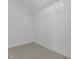 A walk-in closet features neutral carpeting and a metal shelving system for convenient storage solutions at 10410 Sablewood Dr # 111, Raleigh, NC 27617