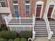 View of the front porch features a set of chairs with a beautiful entrance and landscaped lawn at 10410 Sablewood Dr # 111, Raleigh, NC 27617