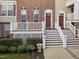 Charming townhome exteriors featuring private entrance with well-maintained landscaping, and covered porch at 10410 Sablewood Dr # 111, Raleigh, NC 27617
