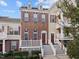 Charming townhome featuring brick facade, purple shutters and a welcoming front porch at 10410 Sablewood Dr # 111, Raleigh, NC 27617