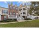 Charming townhome showcasing a well-manicured lawn, inviting entryway, and brick facade with elegant purple shutters at 10410 Sablewood Dr # 111, Raleigh, NC 27617