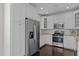 Bright kitchen featuring stainless steel appliances, granite countertops and white cabinetry at 10410 Sablewood Dr # 111, Raleigh, NC 27617