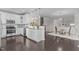 Open concept kitchen with stainless appliances, island, and adjacent seating area at 10410 Sablewood Dr # 111, Raleigh, NC 27617