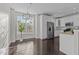 Bright kitchen with stainless steel appliances, white cabinetry, and dark wood floors at 10410 Sablewood Dr # 111, Raleigh, NC 27617