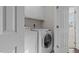 Convenient laundry room featuring a washer, dryer, and ample cabinet space at 10410 Sablewood Dr # 111, Raleigh, NC 27617