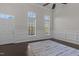 Sun-filled living room with dark floors, wainscoting, and large windows offering plenty of natural light at 10410 Sablewood Dr # 111, Raleigh, NC 27617