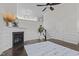Open living room featuring a fireplace, staircase, wainscoting, and plenty of natural light at 10410 Sablewood Dr # 111, Raleigh, NC 27617