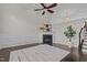 Inviting living room with cozy fireplace, wainscoting, ceiling fan, and staircase leading to the upper level at 10410 Sablewood Dr # 111, Raleigh, NC 27617