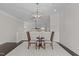 Upstairs loft featuring a modern pendant light, two chairs, and a small table over dark hardwood floors at 10410 Sablewood Dr # 111, Raleigh, NC 27617