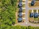 An aerial view showcases a modern residential community nestled alongside lush green trees at 105 Scoville Rd, Garner, NC 27529