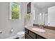 Bathroom features a window over the toilet, a vanity sink, and glass enclosed shower at 105 Scoville Rd, Garner, NC 27529