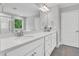 Bathroom featuring double sinks with white quartz countertops, white cabinets, and tile flooring at 105 Scoville Rd, Garner, NC 27529