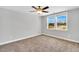 Neutral bedroom with carpet, ceiling fan, and windows providing ample natural light at 105 Scoville Rd, Garner, NC 27529