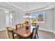 Elegant dining room featuring a wooden table, chandelier, and large window with natural light at 105 Scoville Rd, Garner, NC 27529