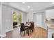 Dining room with wood floors and a sliding glass door leading to a screened porch at 105 Scoville Rd, Garner, NC 27529