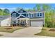 Well-maintained two-story home with a two-car garage and beautifully landscaped front yard at 105 Scoville Rd, Garner, NC 27529