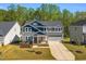 Two-story home with manicured lawn, a two car garage, and inviting curb appeal at 105 Scoville Rd, Garner, NC 27529