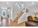 Bright foyer with hardwood floors, stairway with carpet, and inviting living space at 105 Scoville Rd, Garner, NC 27529