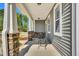 Cozy front porch featuring stone accents, elegant columns, and an inviting seating area at 105 Scoville Rd, Garner, NC 27529