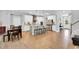 Spacious kitchen featuring an island, stainless appliances, white cabinets, and wood floors at 105 Scoville Rd, Garner, NC 27529