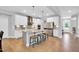 Modern kitchen with stainless steel appliances, granite counters, white cabinets, island, and wood floors at 105 Scoville Rd, Garner, NC 27529
