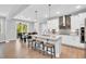 Open kitchen with modern appliances, white cabinetry, island with seating, and adjacent dining area at 105 Scoville Rd, Garner, NC 27529