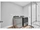 Functional laundry area with modern washer and dryer set and ample storage shelving at 105 Scoville Rd, Garner, NC 27529
