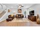 Inviting living room features a plush rug, leather furniture, ceiling fan, and natural light at 105 Scoville Rd, Garner, NC 27529