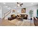Cozy living room showcasing wood floors, brown leather seating, plush rug, and decorative artwork at 105 Scoville Rd, Garner, NC 27529