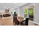 Open-concept living space with wood floors, dining area, living room, and screened porch access at 105 Scoville Rd, Garner, NC 27529