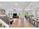 Bright, open living space with wood floors, ceiling fan, open floorplan, and access to porch at 105 Scoville Rd, Garner, NC 27529