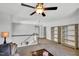 Spacious loft with ceiling fan, neutral walls, and open shelving for storage at 105 Scoville Rd, Garner, NC 27529