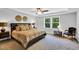 Serene main bedroom with tray ceiling, large windows with view, and designer decor at 105 Scoville Rd, Garner, NC 27529