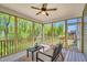 Relaxing screened porch with wood floors, a comfortable seating area, and views of the woods at 105 Scoville Rd, Garner, NC 27529