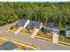 An aerial image highlighting homes with manicured lawns and landscaping backing to wooded area at 105 Scoville Rd, Garner, NC 27529