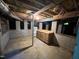 Unfinished basement offering potential for customization, with a workbench and utilities at 106 Orchard Rd, Henderson, NC 27536