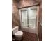 Bathroom featuring a tiled shower with glass doors and a comfort height toilet at 106 Orchard Rd, Henderson, NC 27536