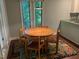 Charming dining area with a round table, four chairs, and a view of the outdoor foliage at 106 Orchard Rd, Henderson, NC 27536