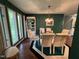 Bright dining room features a modern chandelier, a glass table, and oversized windows at 106 Orchard Rd, Henderson, NC 27536