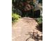 View of the driveway leading to the house with a covered parking area and side building at 106 Orchard Rd, Henderson, NC 27536