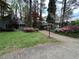 Charming home with a well-manicured lawn, mature landscaping, and a convenient carport at 106 Orchard Rd, Henderson, NC 27536