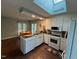 Bright kitchen features a skylight and white appliances at 106 Orchard Rd, Henderson, NC 27536
