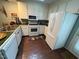 White kitchen with stainless steel appliances and green tile countertops at 106 Orchard Rd, Henderson, NC 27536