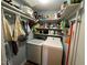 Functional laundry room showcasing a washer, dryer, and ample shelving for storage at 106 Orchard Rd, Henderson, NC 27536