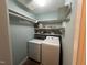 Functional laundry room with washer, dryer, and shelving for storage of supplies and essentials at 106 Orchard Rd, Henderson, NC 27536