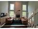 Spacious living room featuring large windows, a fireplace, and comfortable seating at 106 Orchard Rd, Henderson, NC 27536